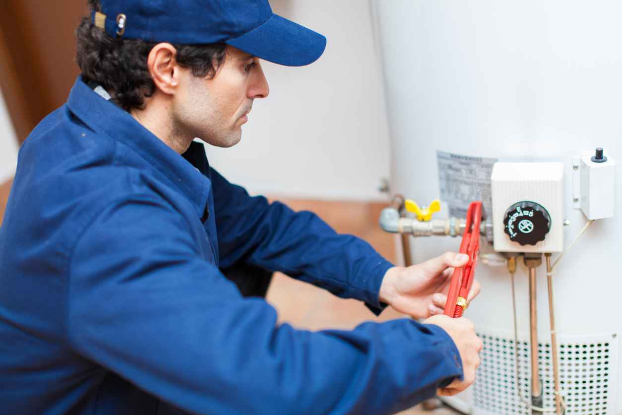 Plumber fixing a hot water heater