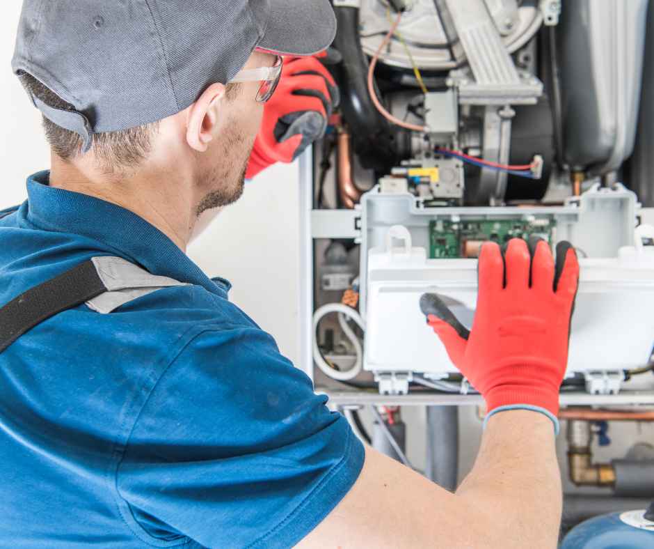 A man working on a furnace