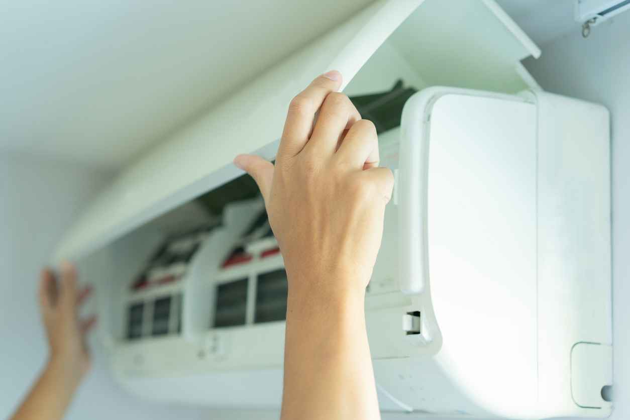 Close-up of an HVAC technician replacing a mini-split unit