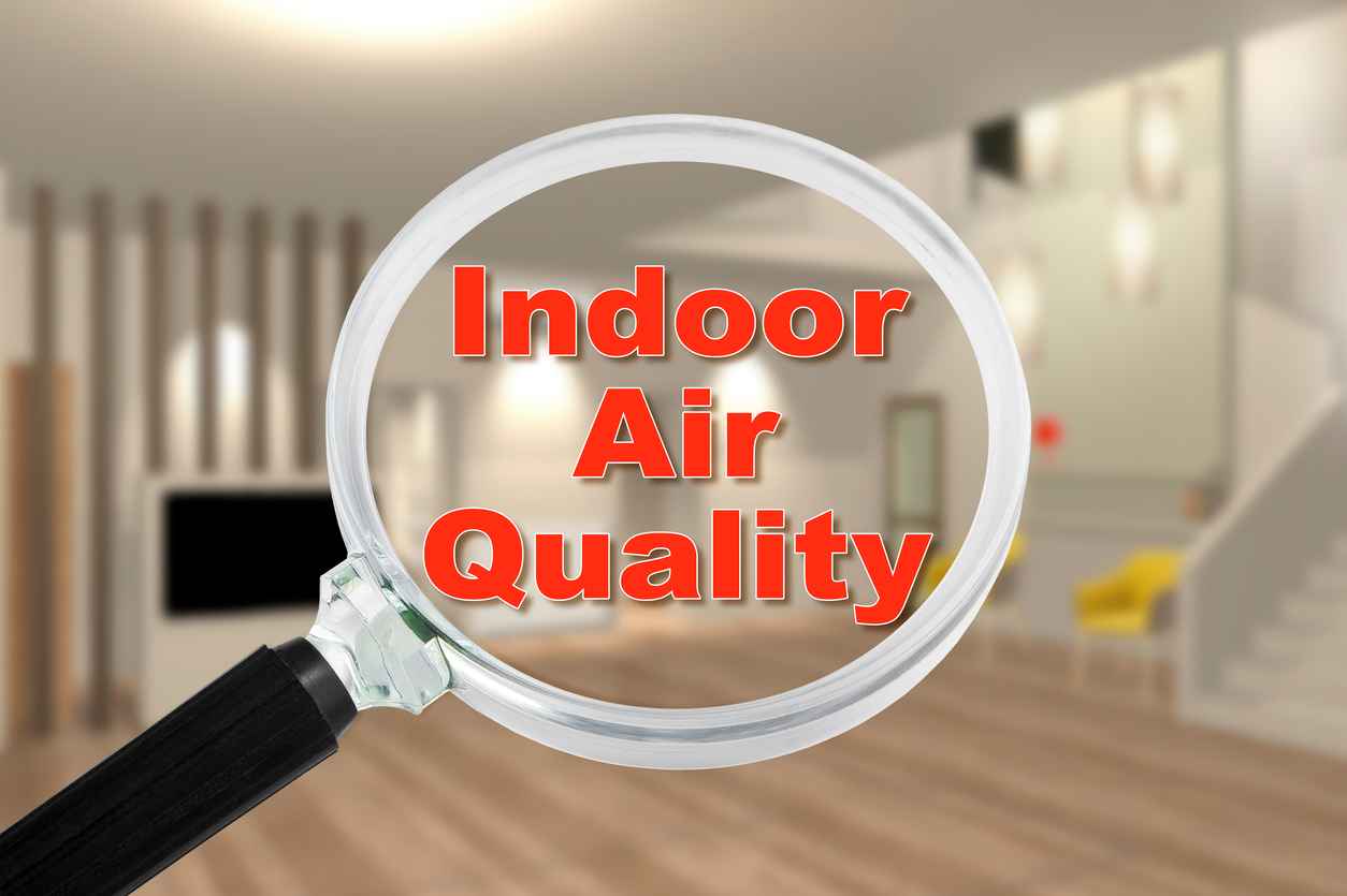 Concept of testing indoor air quality in a residential home through a magnifying glass