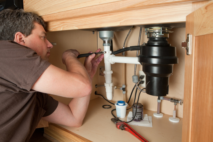 Technician Repairing Garbage Disposal